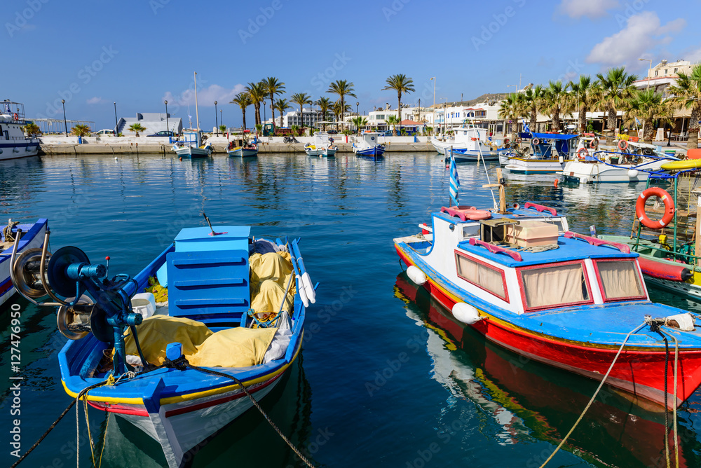 The scenic harbour with traditional fishing boats in the village of Kardamena, Kos island, Dodecanese, Greece.