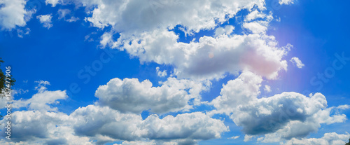 Looking up view of panorama blue sky with clouds and sun reflection