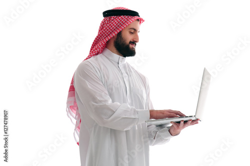 Arabian Man Working On A notebook, standing over a white background, business concept