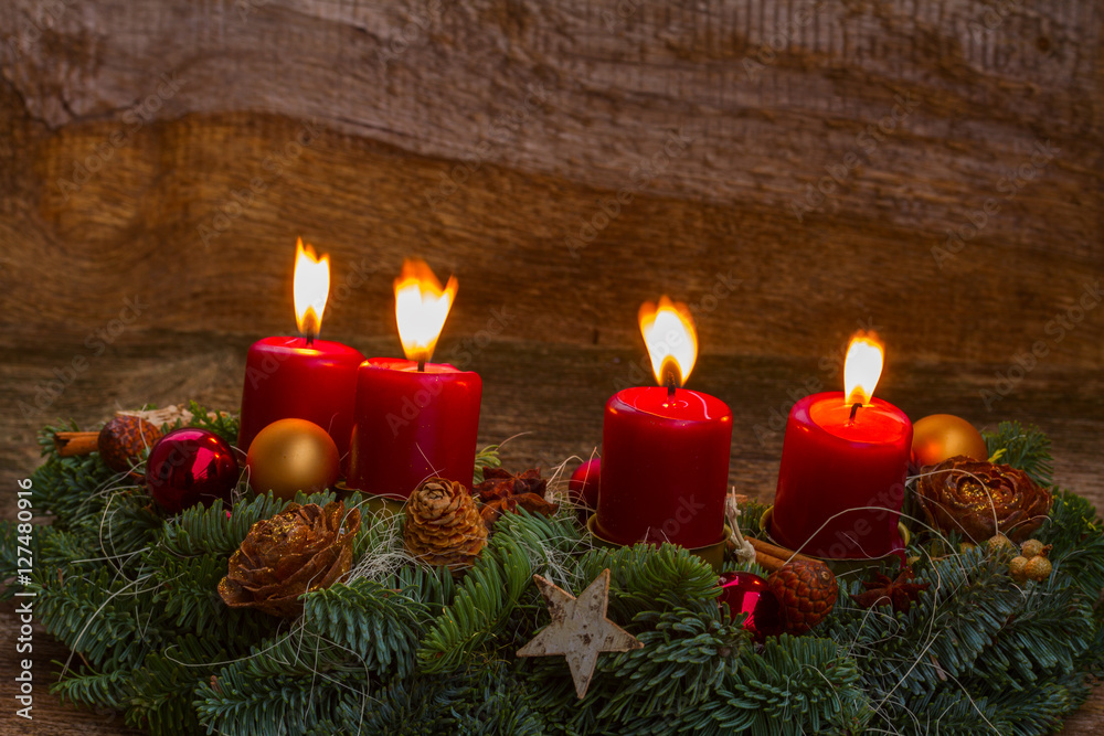 Evergreen fir tree advent garland with four red burning candles on wooden bakcground Evergreen fir tree advent garland with four red burning candles on wooden bakcground