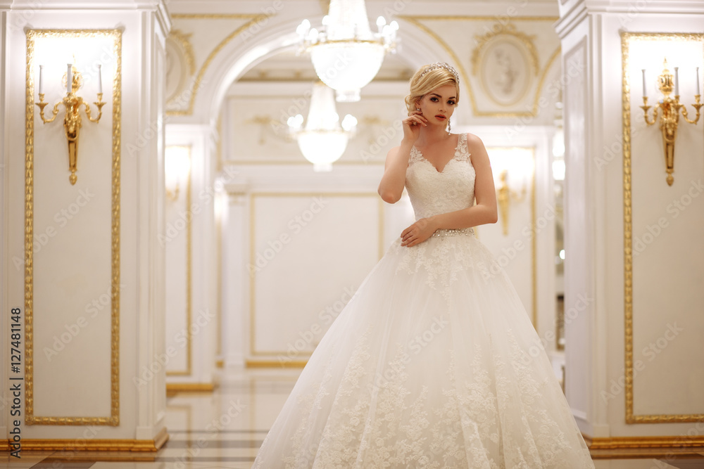 Fototapeta premium beautiful young woman bride in luxury wedding dress in interior