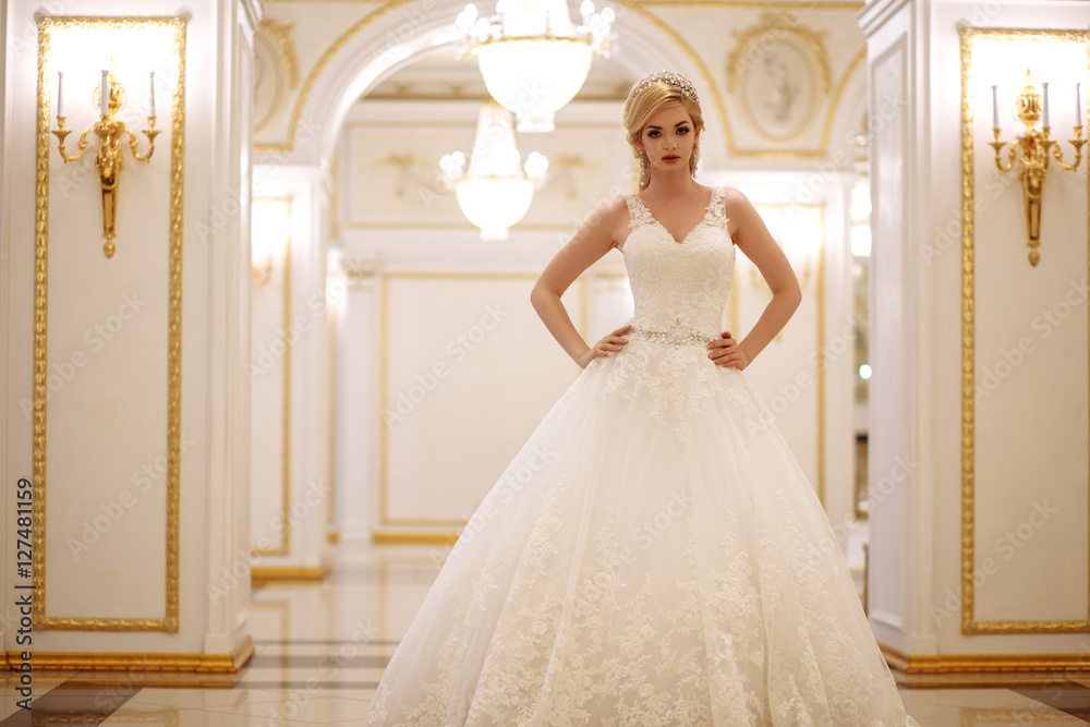 Fototapeta premium beautiful young woman bride in luxury wedding dress in interior