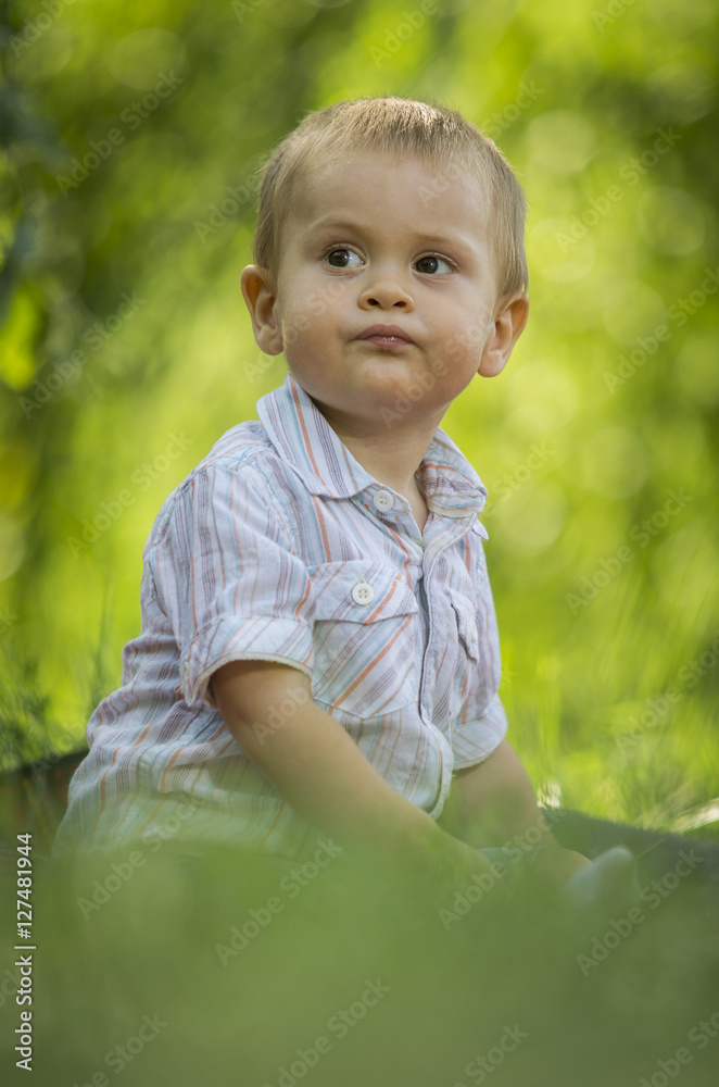 Boy playing in green park