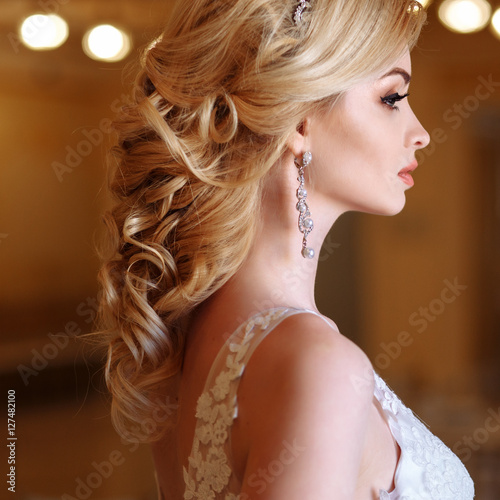 beautiful young woman bride in luxury wedding dress in interior