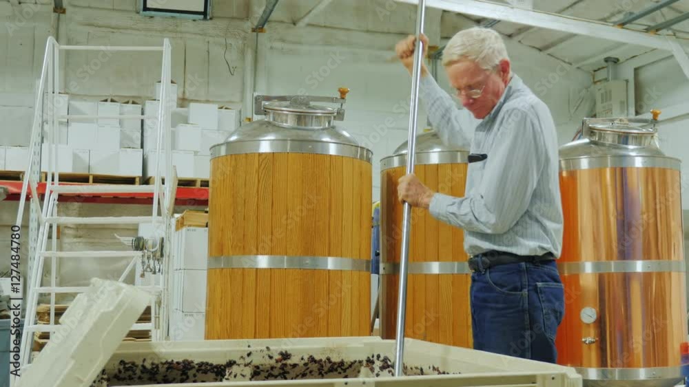 Work in the winery. Punch down cap Work in the winery. Punch down cap