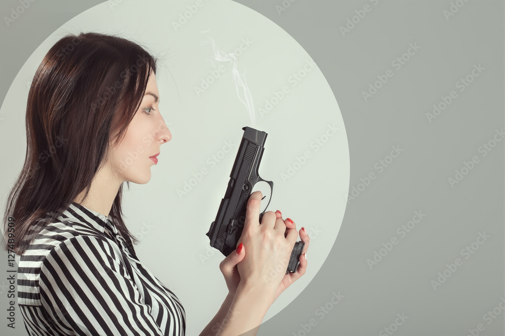 wuman with gun profile on white background with copyspace toned image wuman with gun profile on white background with copyspace toned image