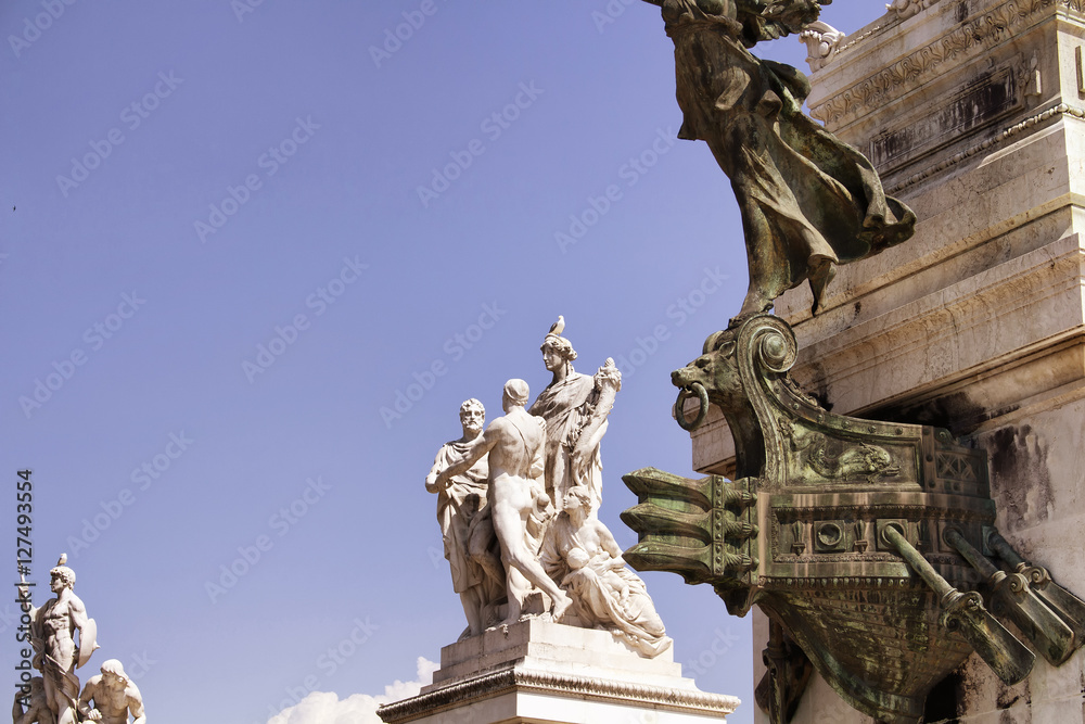 View of statues at Altar of the Fatherland in Rome. Grand marble, classical temple honoring Italy's first king & First World War soldiers.