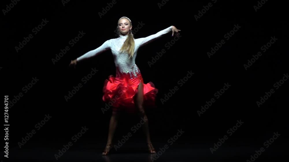 Woman dancing ballroom-sports dance, dark background. Slow motion Woman dancing ballroom-sports dance, dark background. Slow motion