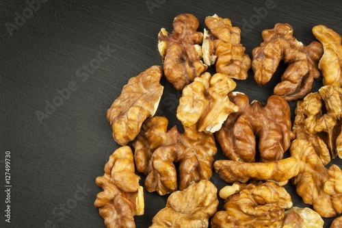 Closeup of big shelled walnuts pile. We like walnuts. Advertising on walnuts. Superfoods for the human brain.
