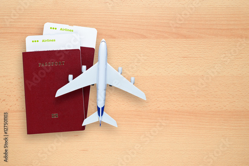 Boarding passes, passports and toy aircraft on desk