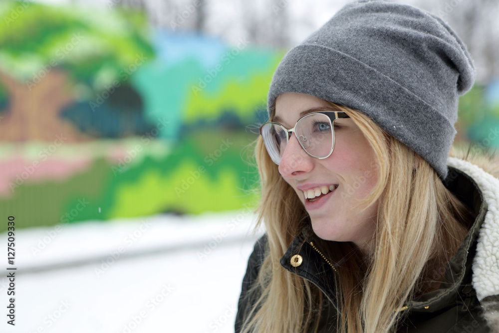 Smiling teen in glasses on bench Smiling teen in glasses on bench
