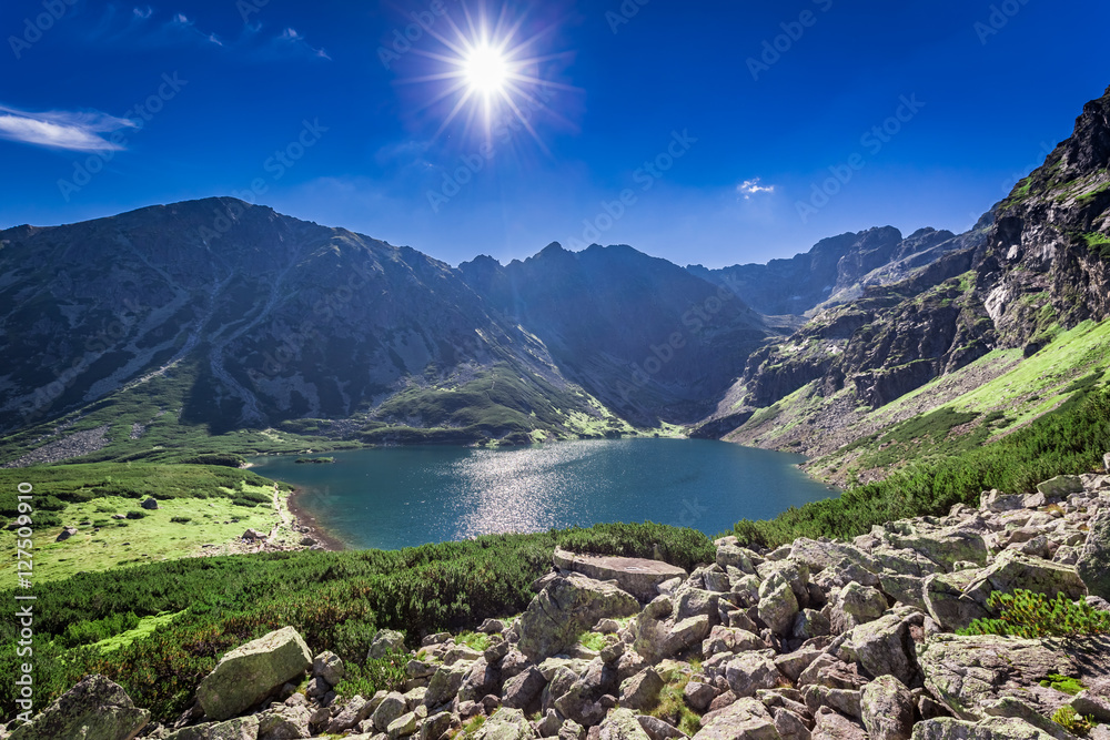 Fototapeta premium Breathtaking sunrise over Czarny Staw Gasienicowy in summer, Tatras