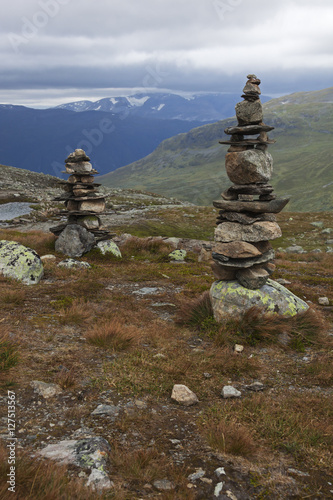 Stone pyramids over murky mountain landscape, Norway © Arkadii Shandarov