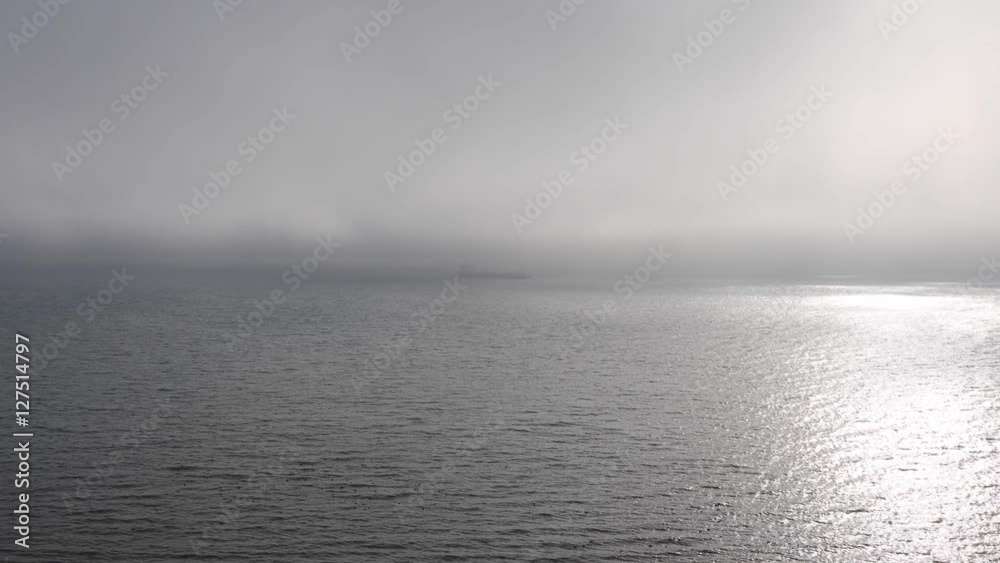 The ship is anchored in the seaport water area in thick fog
The ship is anchored in the seaport water area in thick fog
