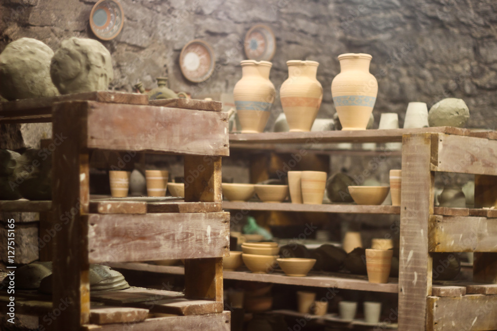 Shelves with pottery in a pottery workshop Shelves with pottery in a pottery workshop