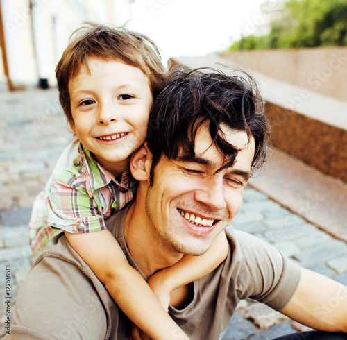 little son with father in city hagging and smiling, casual look  photo