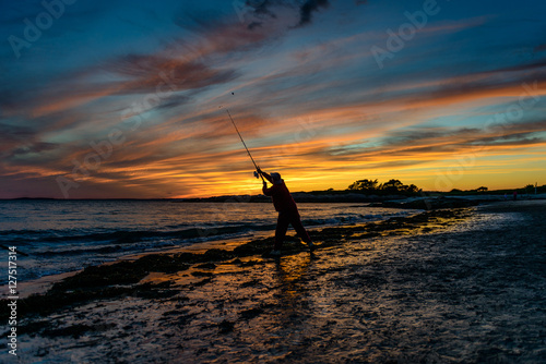 Surf Casting At Sunset