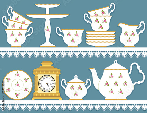 White tea set with roses motif and clock on lace  tablecloth
