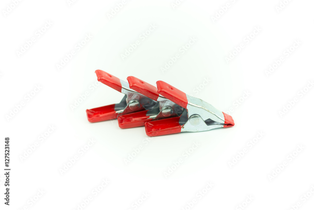 Metal spring clamp with red plastic isolated on white Metal spring clamp with red plastic isolated on white