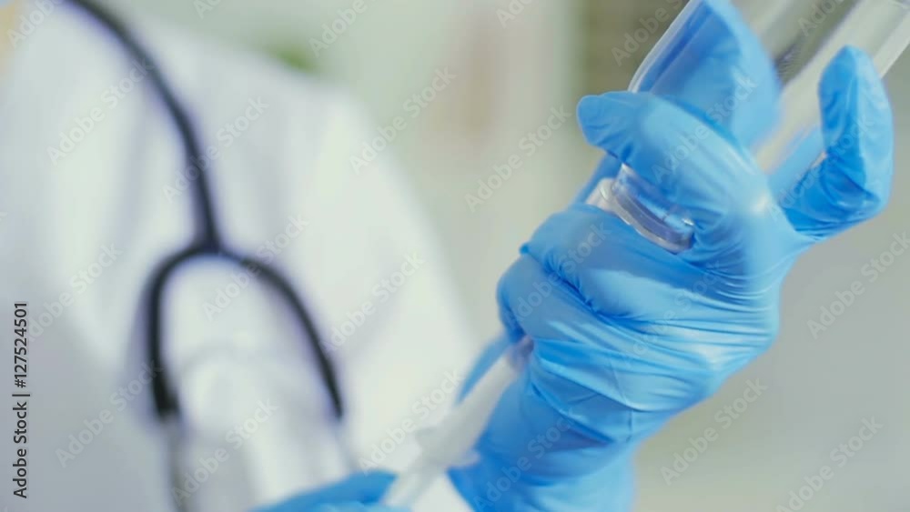 The young graduate student gathers medicine in a syringe