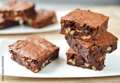 Brownie stack, closeup chocolate cake in plate on rustic wooden