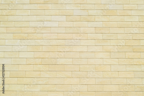 Background of yellow bricks. Wall of yellow bricks. The texture of the wall.