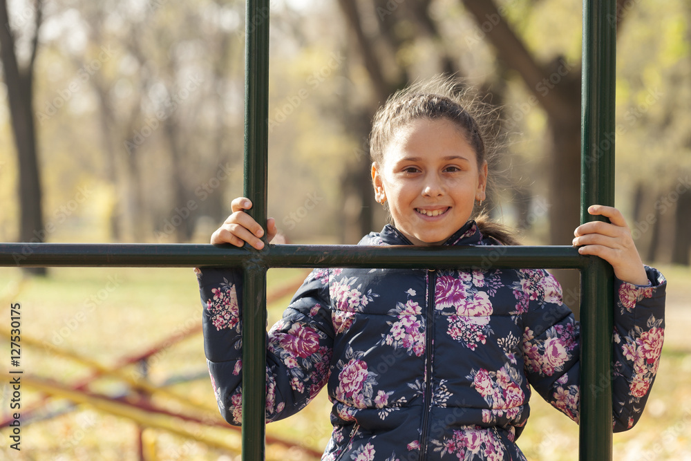 Fototapeta premium The girl playing on the playground