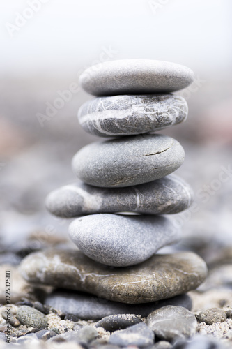 concept of harmony and balance with rocks on the beach. in the background a beach