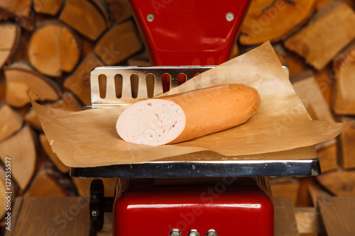 Sausage on red scales photo