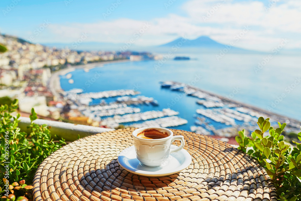 Fototapeta premium Cup of coffee with view on Vesuvius mount in Naples
