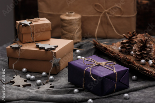Christmas decoration and gift boxes over grey background. © Cookie Studio