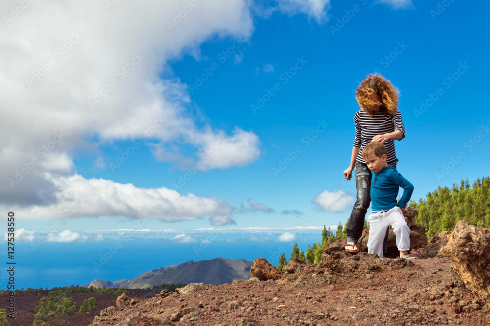 Fototapeta premium Mother and son at top of mountain