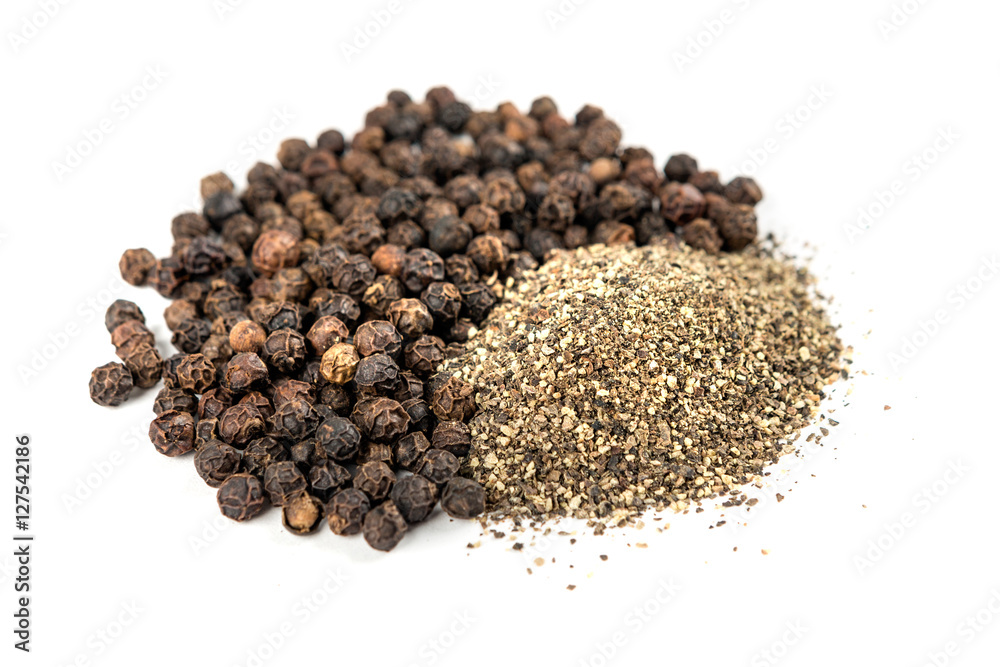 Black peppercorns and ground pepper isolated on white background Black peppercorns and ground pepper isolated on white background