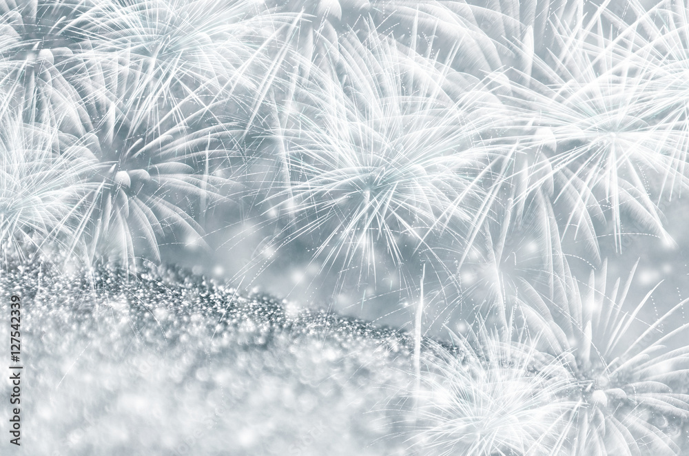 Silver and dark blue fireworks and bokeh on gliter paper at New Year and copy space. Abstract background holiday. Silver and dark blue fireworks and bokeh on gliter paper at New Year and copy space. Abstract background holiday.