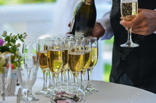 Waiter serving champagne on a tray