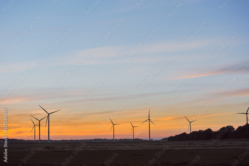 Silhouette of wind turbine on sunset Silhouette of wind turbine on sunset