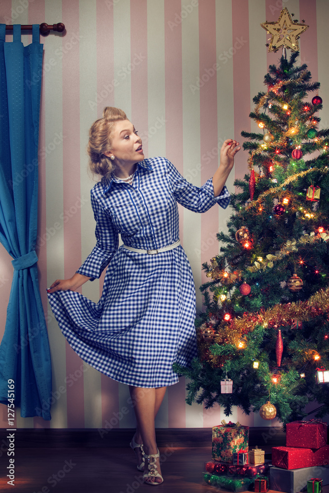 portrait of nice young woman hanging around christmas tree on x-mas eve  Stock Photo | Adobe Stock