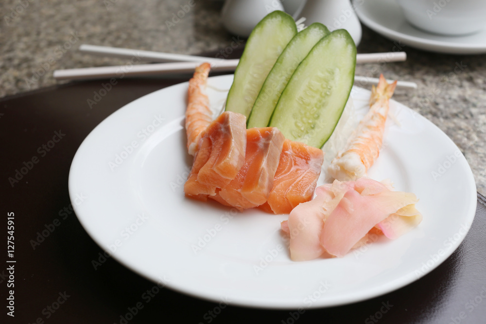 Salmon of sashimi on white dish in a restaurant. Salmon of sashimi on white dish in a restaurant.