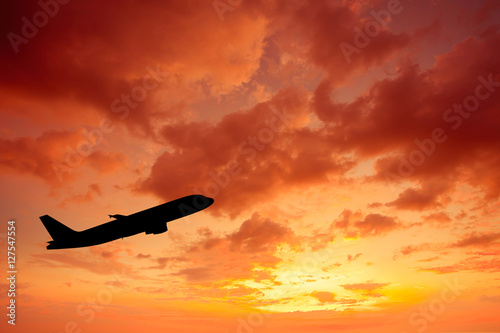 Silhouette of an airplane at sunset.