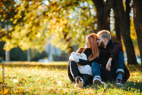 young family and newborn son in autumn park