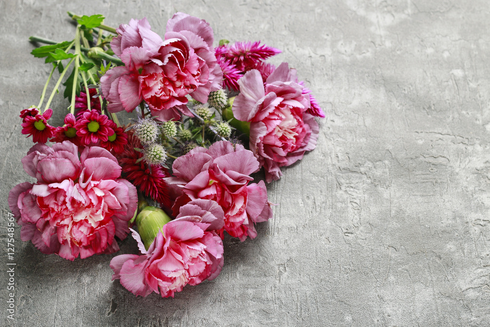 Bouquet of carnation and chrysanthemum flowers on brown wood Bouquet of carnation and chrysanthemum flowers on brown wood