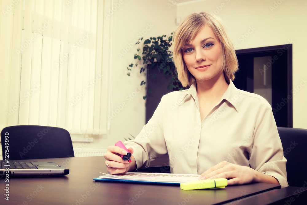 Blonde businesswoman highlighting chart. Business concept Blonde businesswoman highlighting chart. Business concept