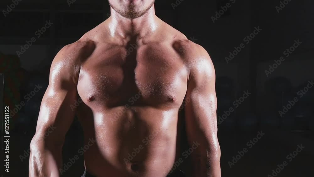 Handsome power athletic man with dumbbell Handsome power athletic man with dumbbell