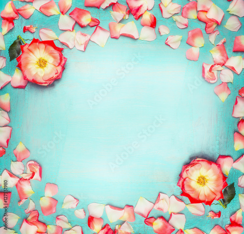 Flowers frame with roses and petals on turquoise  blue shabby chic background, top view, place for text