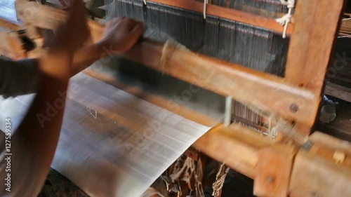 The local worker is weaving with handloom in the factory, Inle lake, Myanmar
