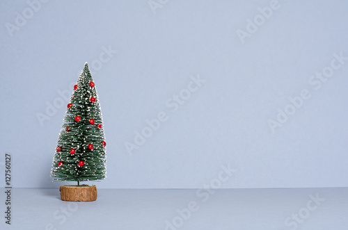 Decorated Christmas tree isolated on light-blue background