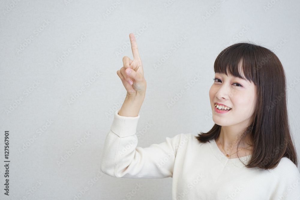 Young woman pointing something with smile Young woman pointing something with smile