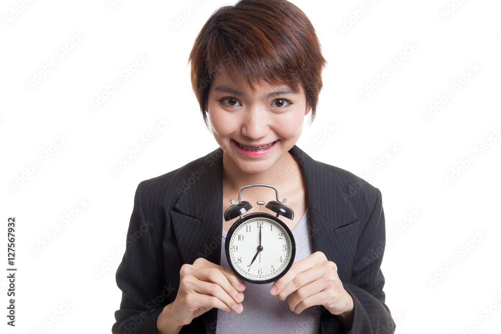 Young Asian business woman smile with a clock. Young Asian business woman smile with a clock.