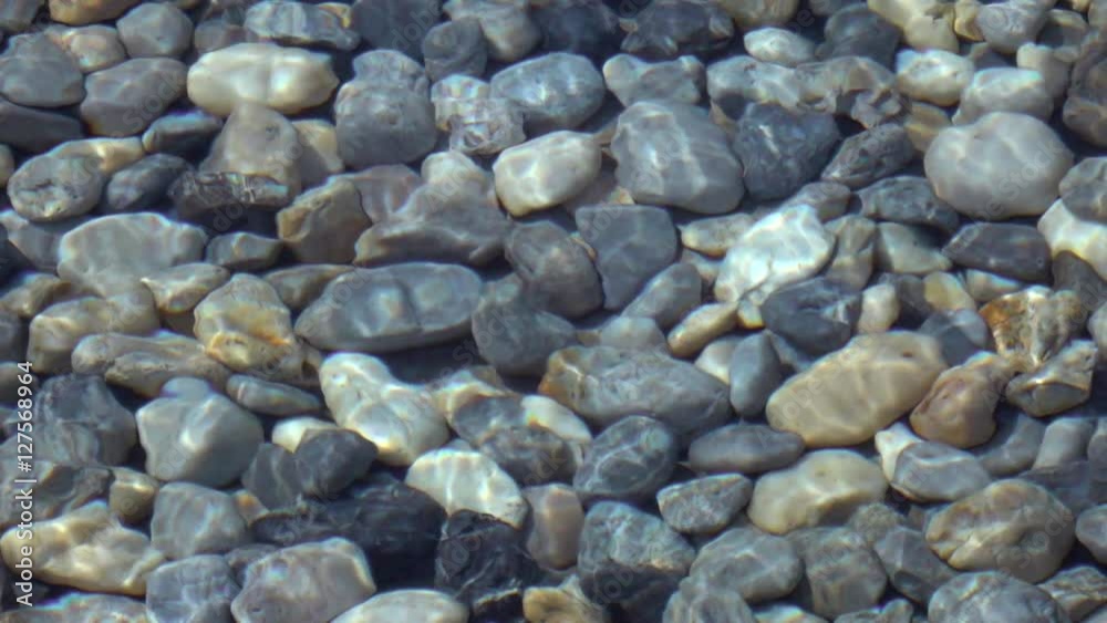 Slow motion, 240fps, of abstract natural background. Beautiful view for amazing intro in excellent eight times decelerated clip. Soft ripple on shallow transparent water surface with pebble bottom. Slow motion, 240fps, of abstract natural background. Beautiful view for amazing intro in excellent eight times decelerated clip. Soft ripple on shallow transparent water surface with pebble bottom.