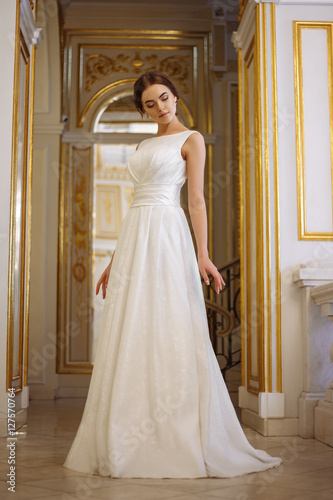 beautiful young woman bride in luxury wedding dress in interior